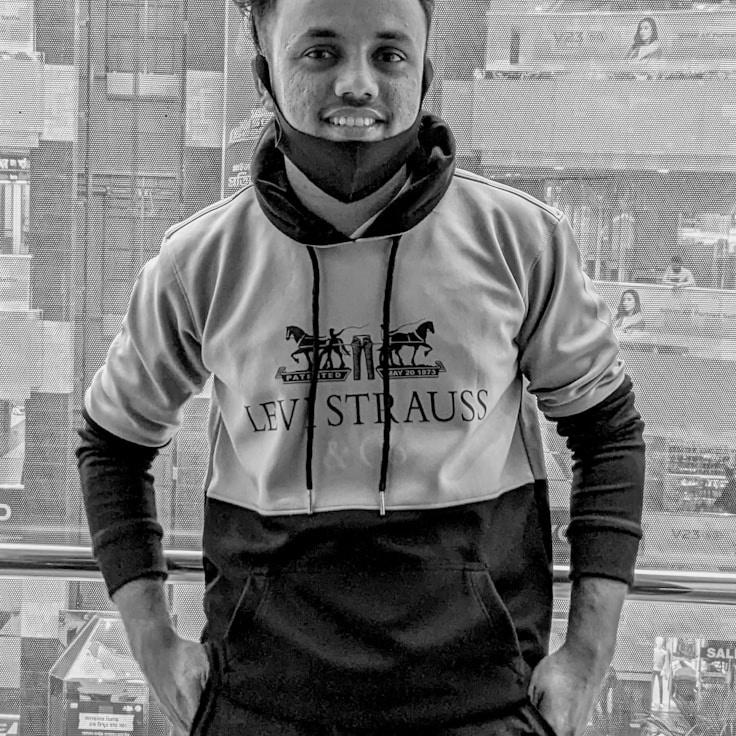 Asha Patel, Lead Design Curator at Kindred Glade Garden, reviewing corporate floral arrangements